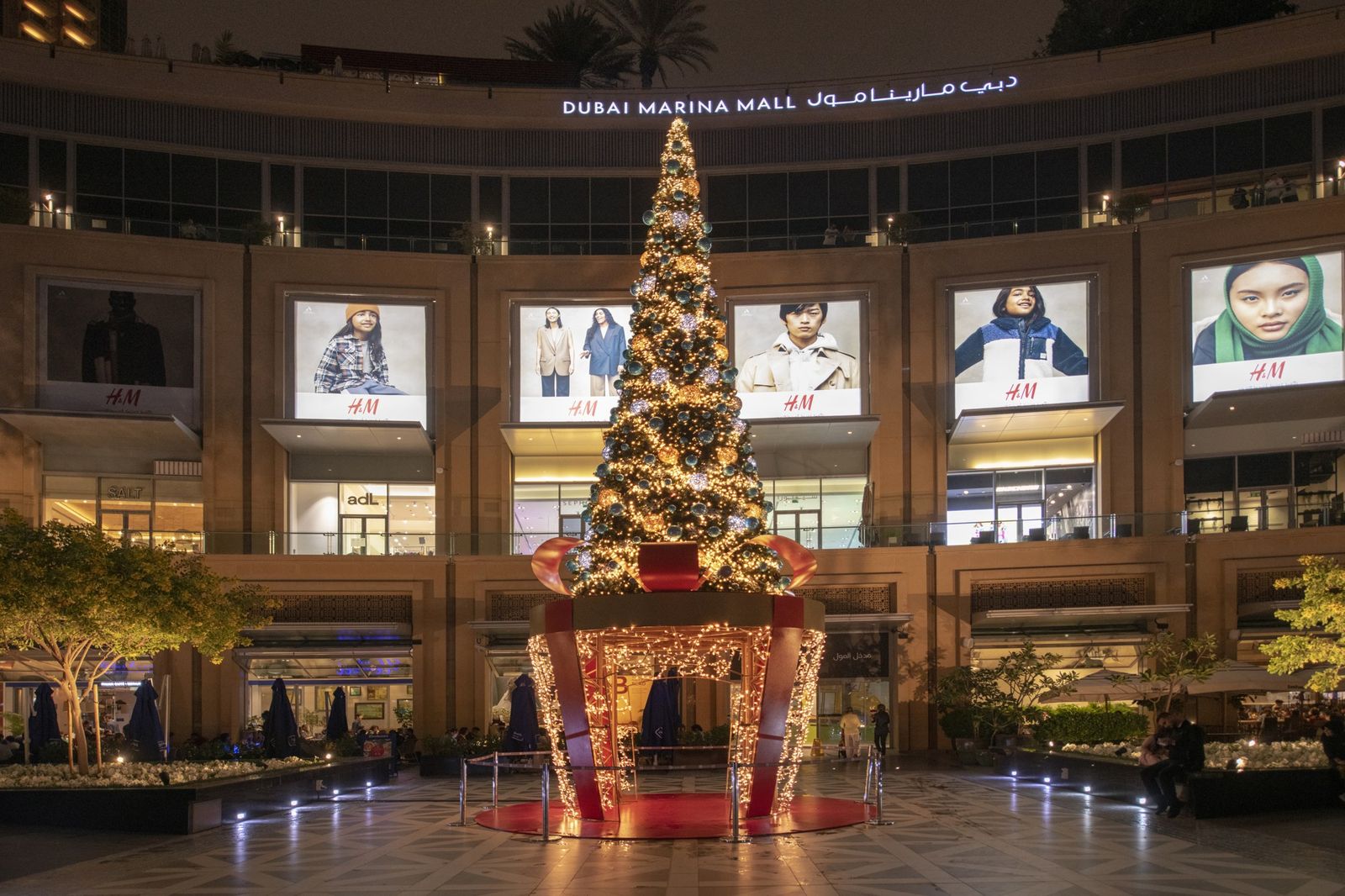 Illuminated Christmas tree installed by Redfox on the outdoor plaza in front of Dubai Marina Mall at night