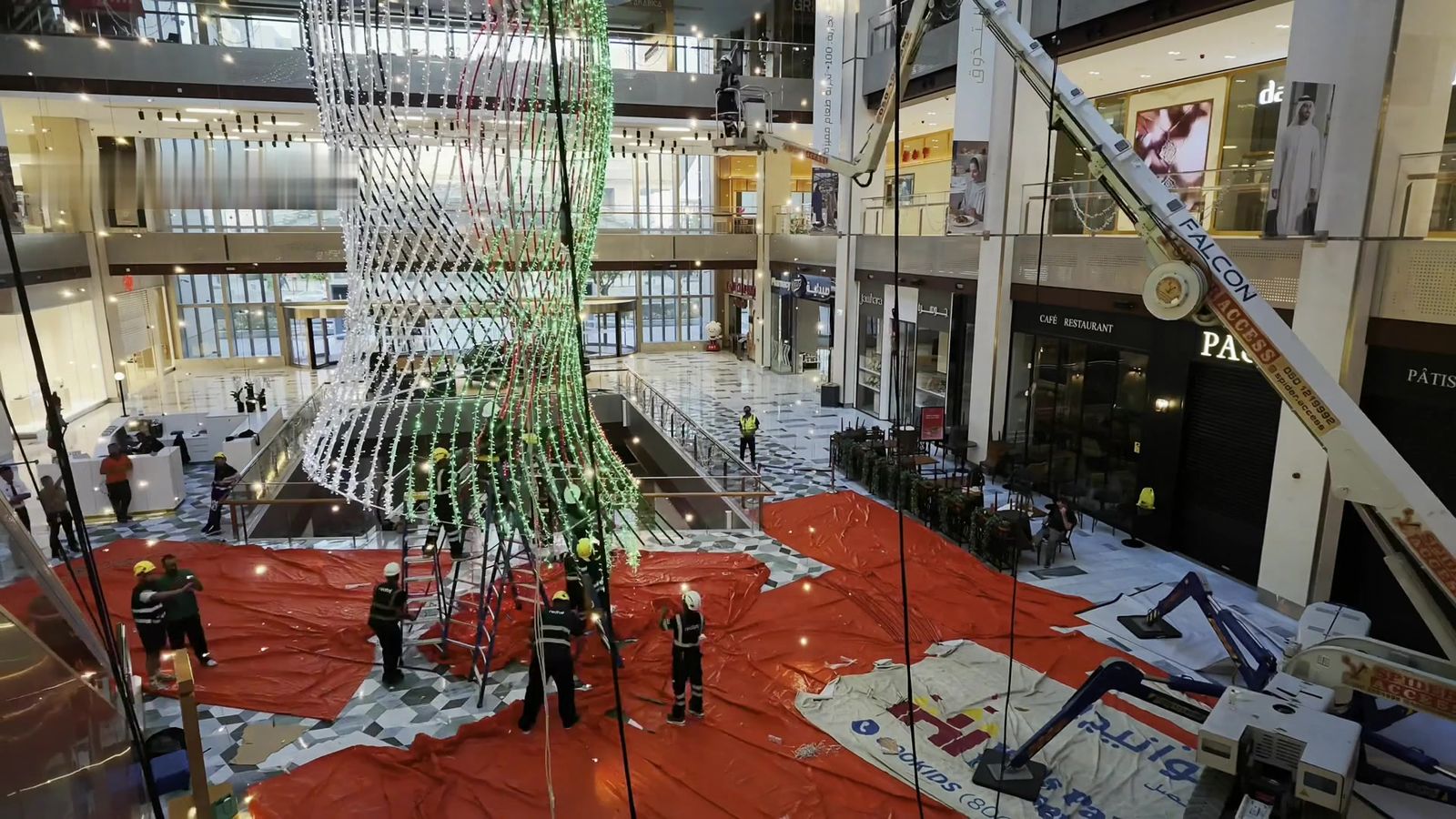 Redfox riggers working beneath the suspended structure in the central atrium of The Galleria Mall, with a spider lift in position