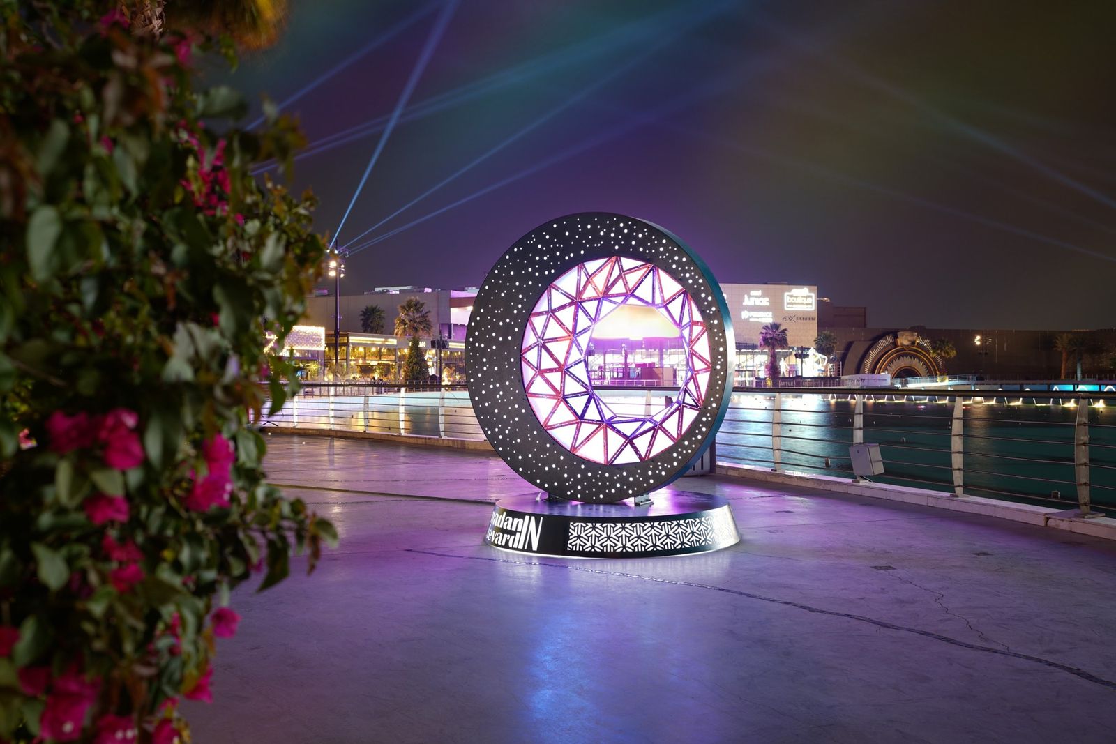 Illuminated crescent feature installed by Redfox beside the water at Boulevard City, Riyadh